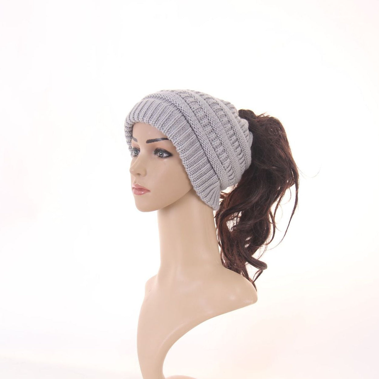 Gray knitted headband worn by a mannequin on a white background