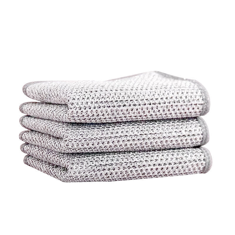 Stack of four folded textured dishwashing cloth on a white background