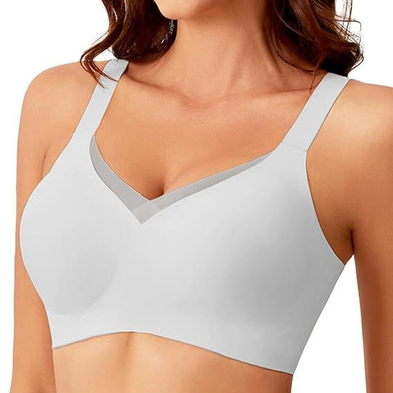 Woman wearing a light gray bra on a white background