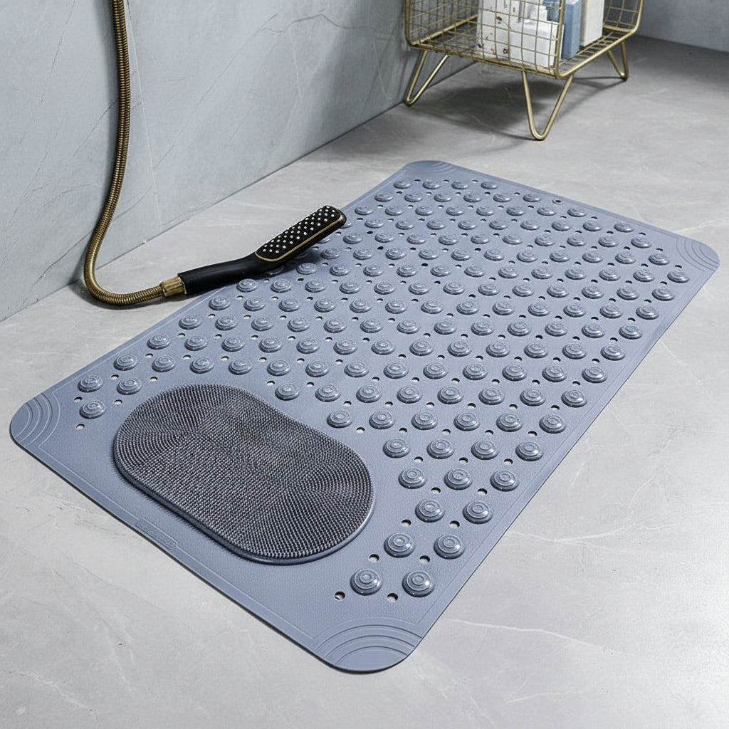 Dark grey bath mat with textured surface on a bathroom floor.