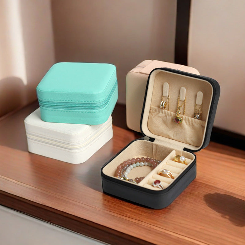 Set of jewelry boxes in different colors on a wooden surface