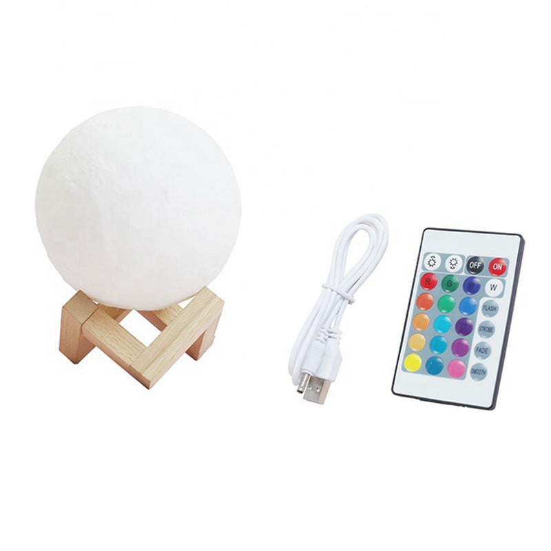 White spherical lamp with wooden stand, USB cable, and remote control on a white background