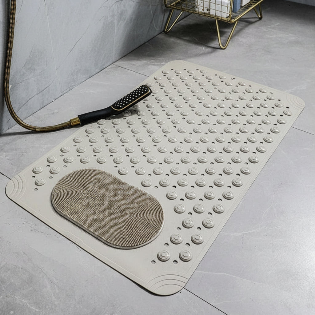 Khaki-colored mat with textured surface on a gray floor, featuring a brush on top.
